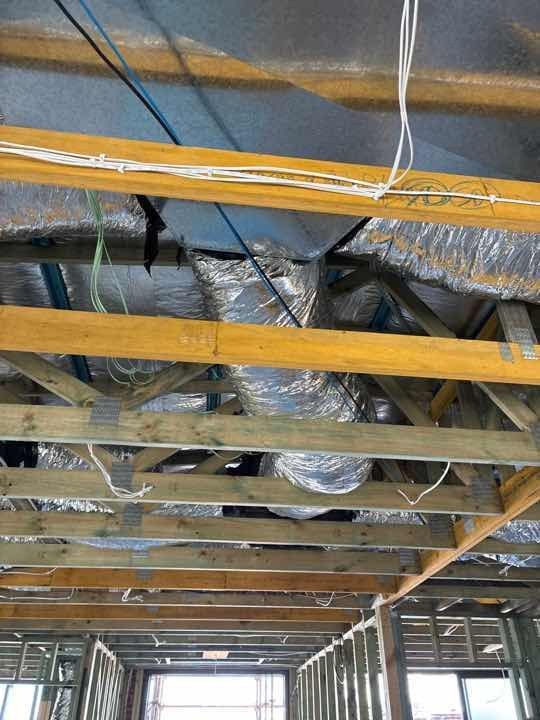 Wall frame bracing incomplete — tension straps require correct fixing before progress to wrap stage.