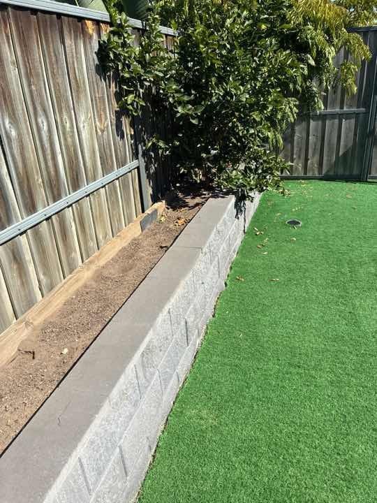 Perimeter soil level against brickwork — lower ground levels to fully expose weep holes.